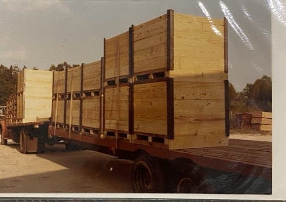 Wooden shipping boxes stacked on a flatbed trailer